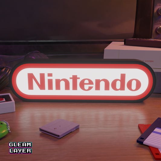 An illuminated LED sign featuring the Nintendo logo, placed on a table with gaming-related items in the background.